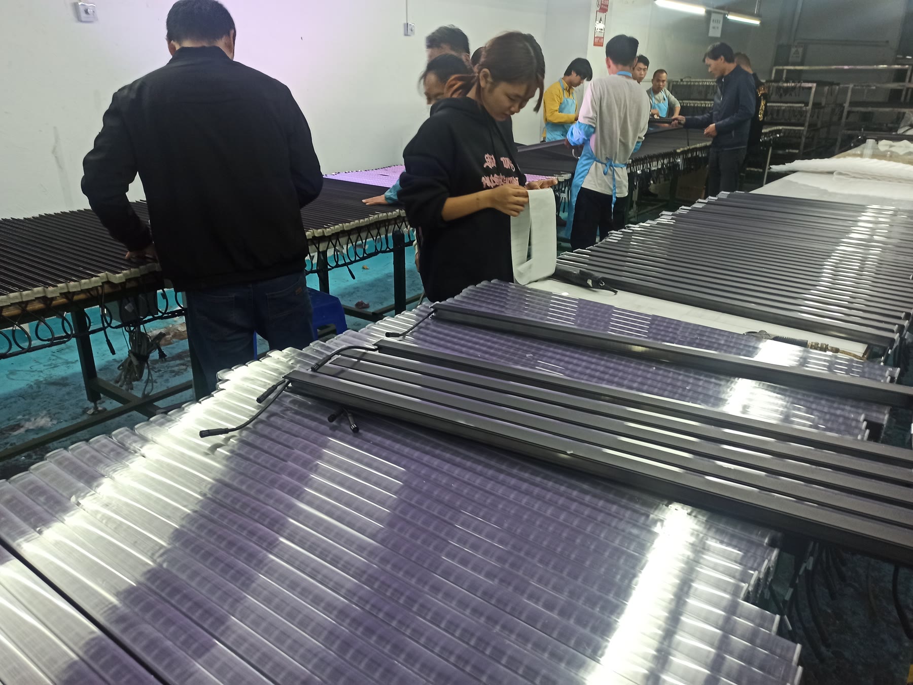 Team members working with linear lighting products