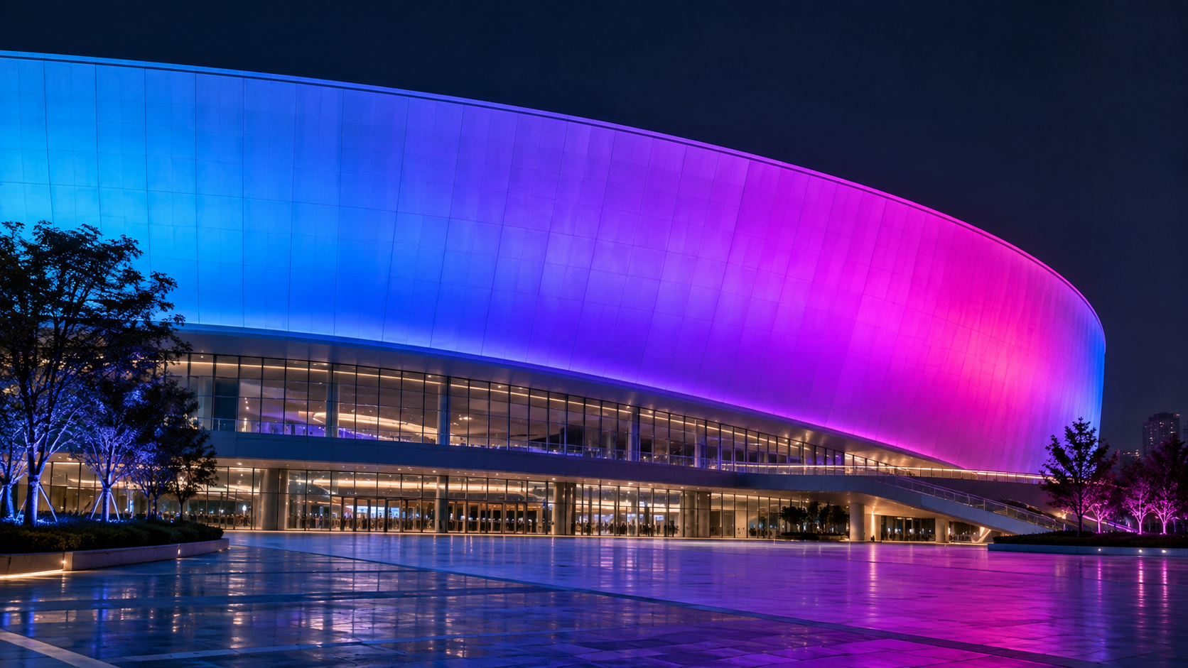 Application illustration — continuous RGB wall washing across a stadium facade.